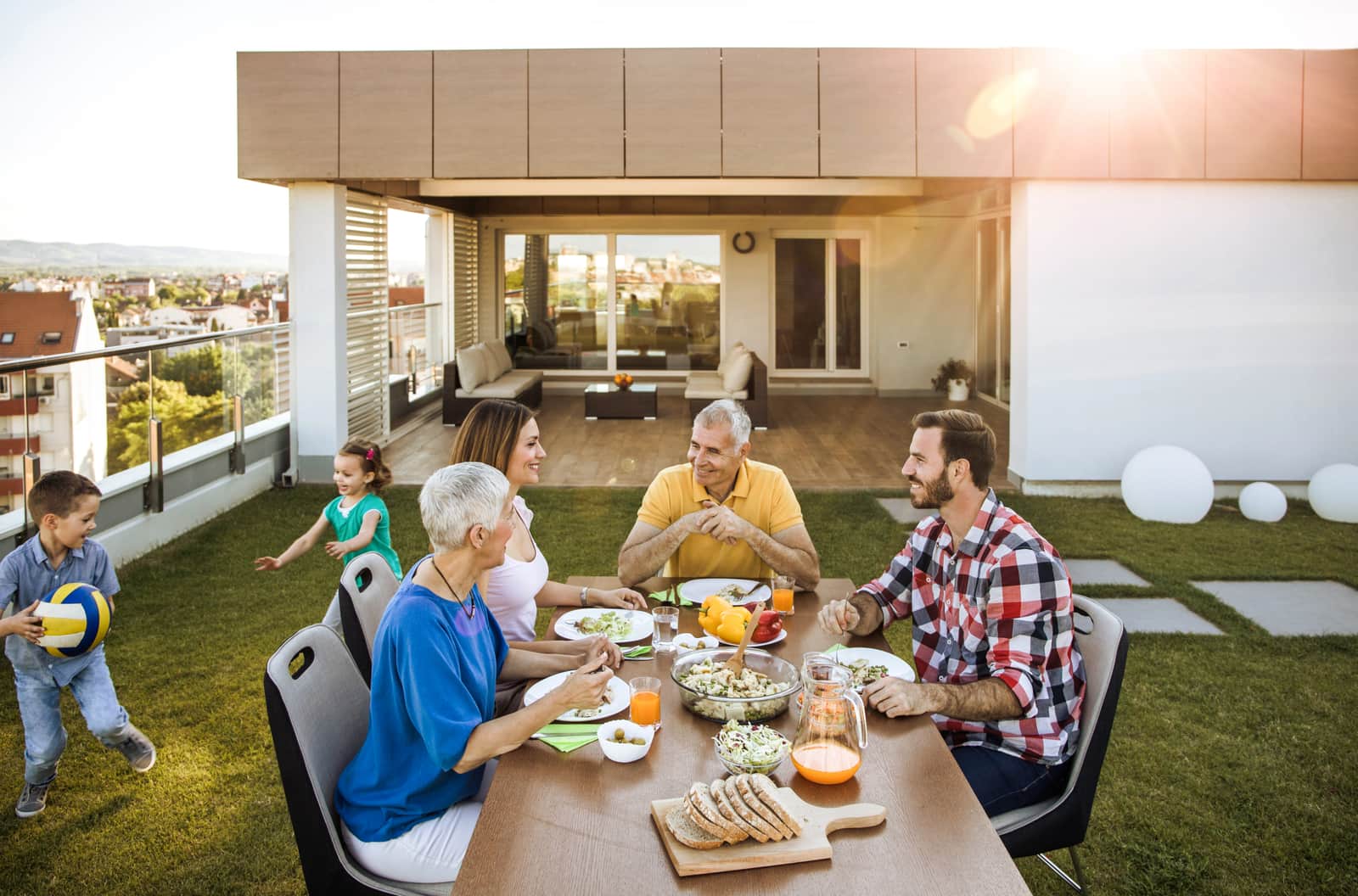 Happy multi-generation family enjoying during a meal on the balcony