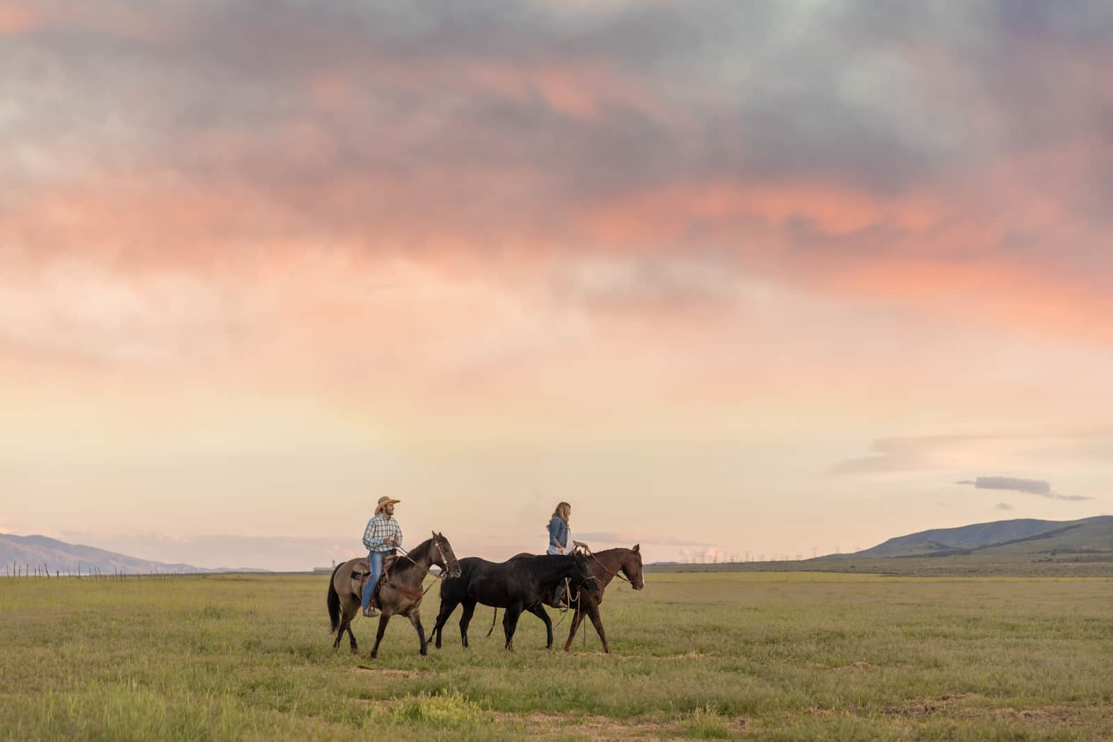 Cowboy and Cowgirl Ride Into the Sunset